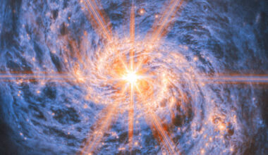 This image of Messier 77 from Webb’s Mid-Infrared Instrument (MIRI) highlights its swirling spiral arms, the dust in its disk and its piercingly bright core like never before. The bright orange lines appearing to radiate out from the galaxy’s center are not actually a feature of the galaxy: they are a type of distortion that arises from the optical design of the telescope. Called diffraction spikes, they are created because the intense light from the unresolved AGN is bent (diffracted) very slightly at the edges of Webb’s hexagonal mirror panels and around one of the struts that hold up its secondary mirror. Image credit: NASA / ESA / CSA / Webb / A. Leroy.
