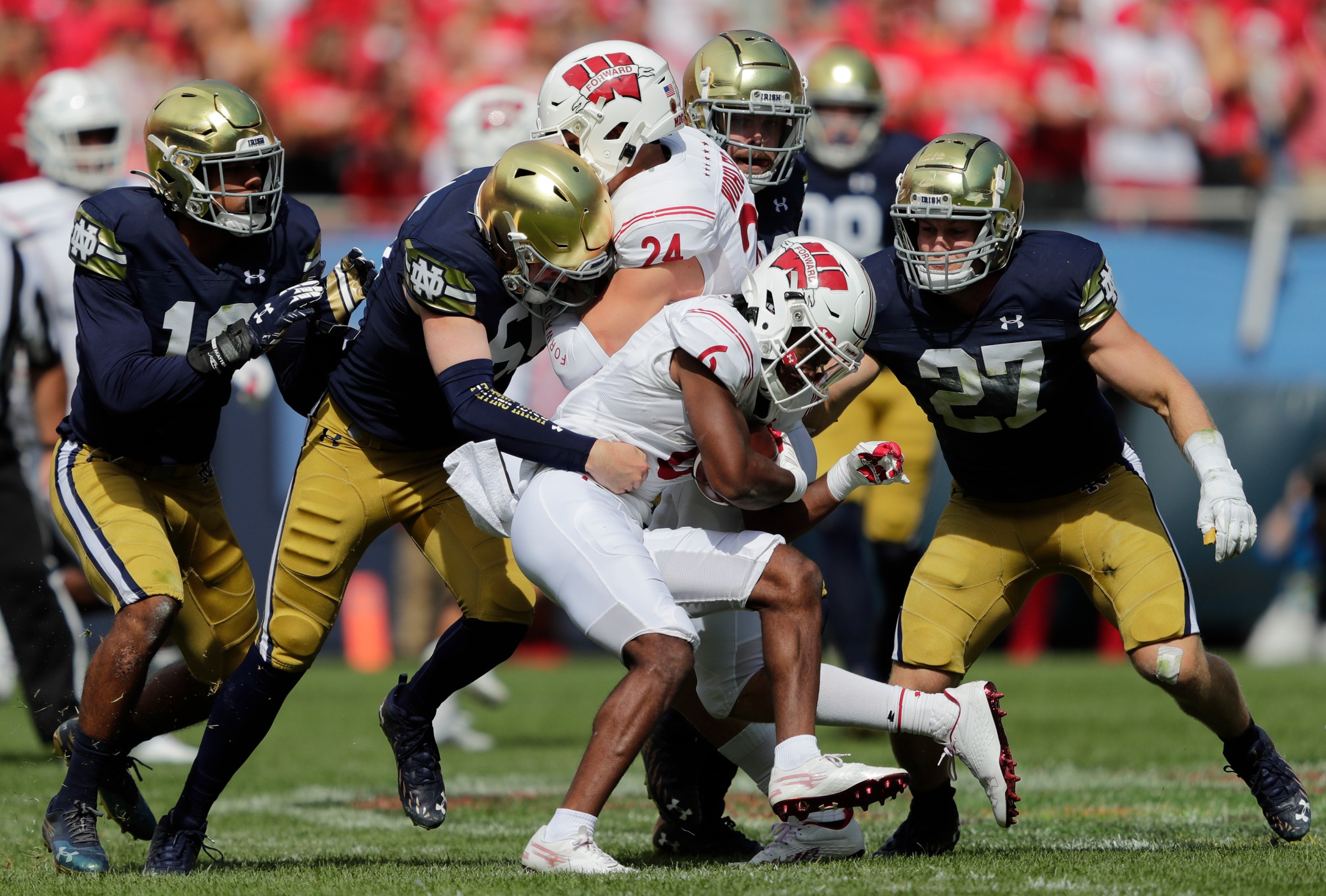 Sep 25, 2021; Chicago, IL, USA; Wisconsin Badgers running back Chez Mellusi (6) is brought down by Notre Dame defenders during their football game Saturday, September 25, 2021, at Soldier Field in Chicago, Ill. Mandatory Credit: Dan Powers-Imagn Images