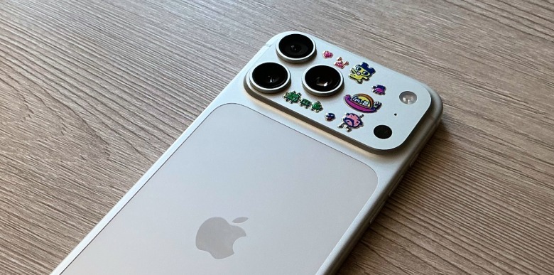 An iPhone 17 Pro with Tamagotchi stickers on its back