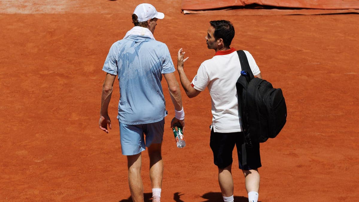 Jannik Sinner leaving the tennis court for medical treatment at the French Open in Paris