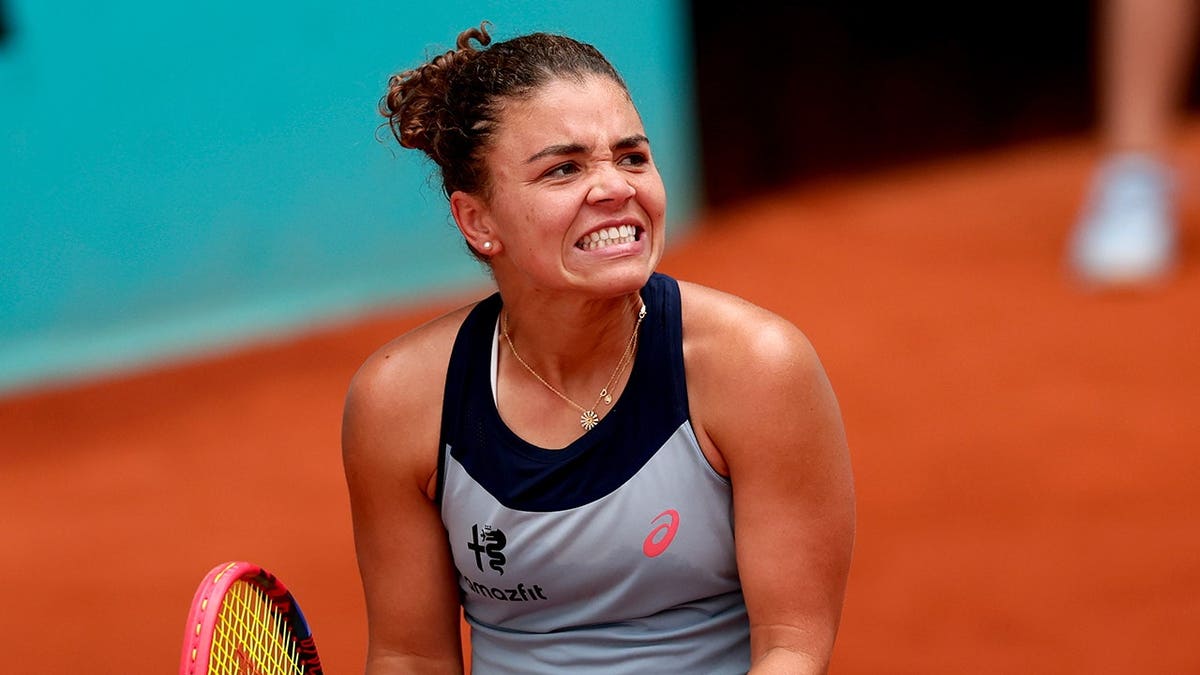 Jasmine Paolini hitting a tennis shot against Hailey Baptiste at the Madrid Open