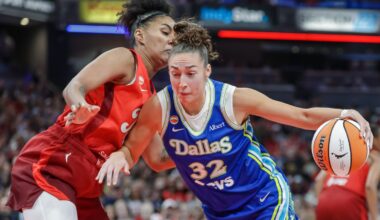 Jessica Shepard (32) of the Dallas Wings drives to the basket against Damiris Dantas (12) of the Indiana Fever.