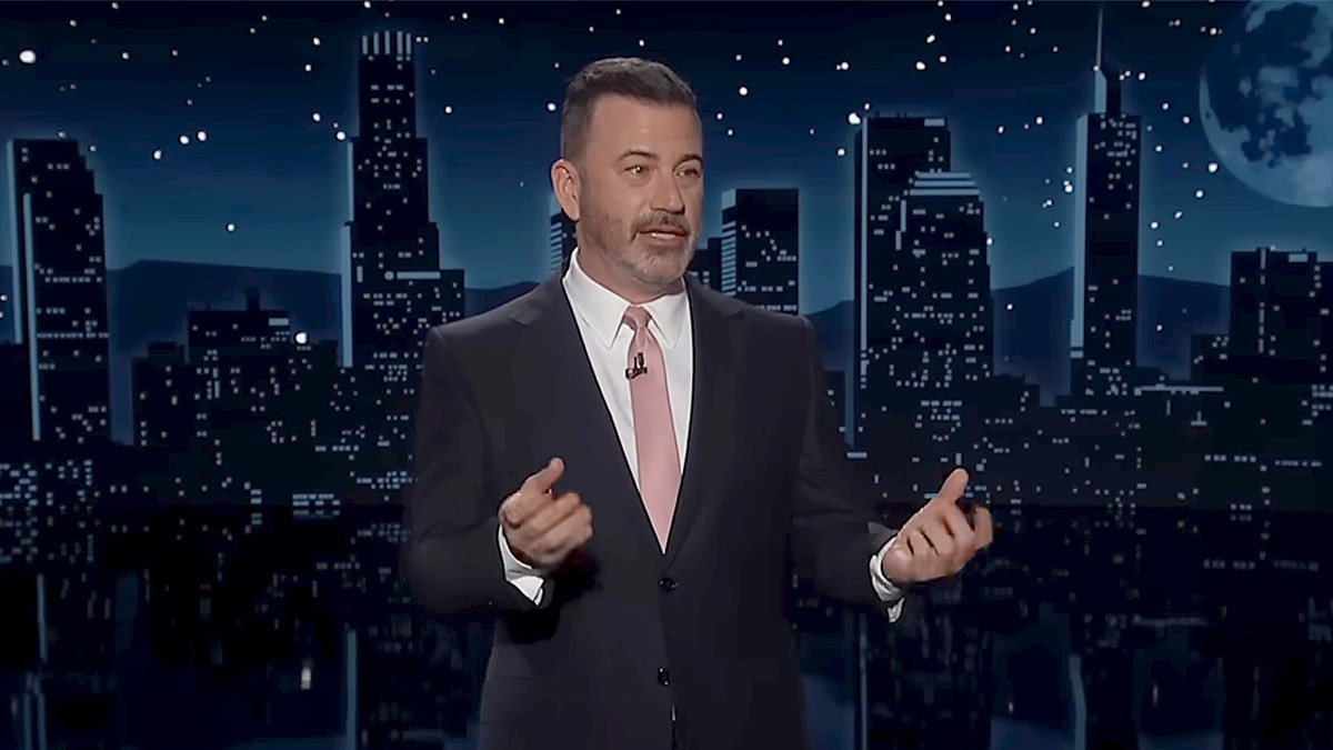 Jimmy Kimmel speaking on stage during his late-night show