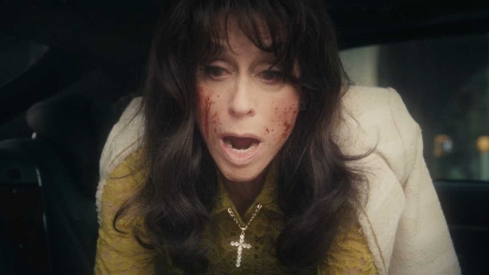 Judith Light's The Punisher: One Last Kill character with her face covered in blood and looking devastated.