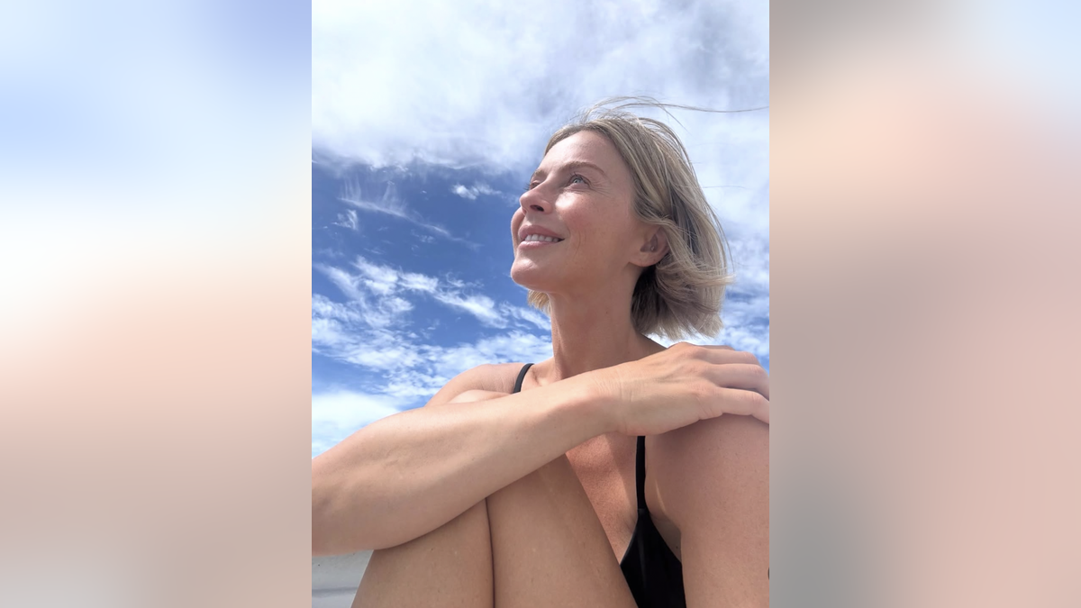 Julianne Hough sits and smiles