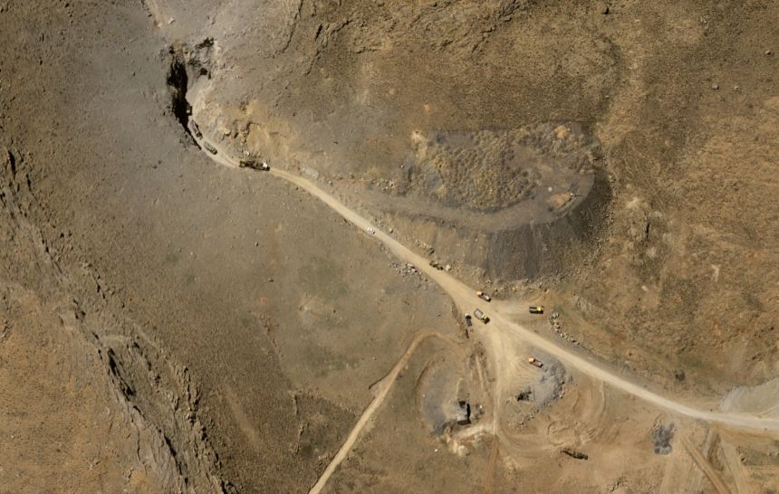 A satellite image of an underground missile base near Khomeyn, Iran, shows at least 10 construction vehicles working to clear a tunnel entrance on April 15, 2026.