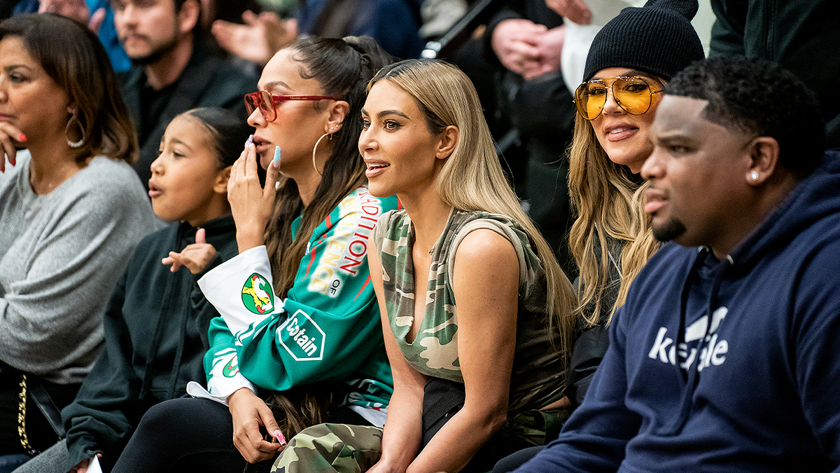 Kim Kardashian seated courtside during a Sierra Canyon basketball game.