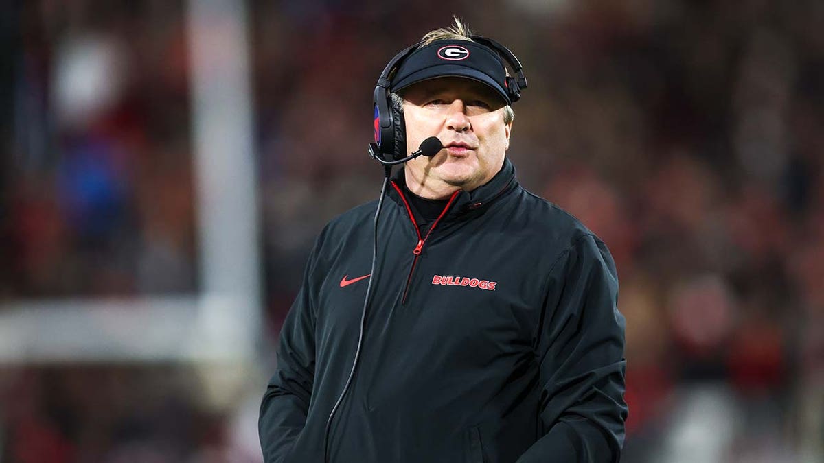 Georgia Bulldogs head coach Kirby Smart standing on the sideline at Sanford Stadium