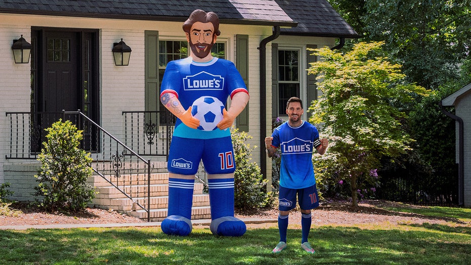 Lionel Messi next to 10-foot inflatable with Lowe's