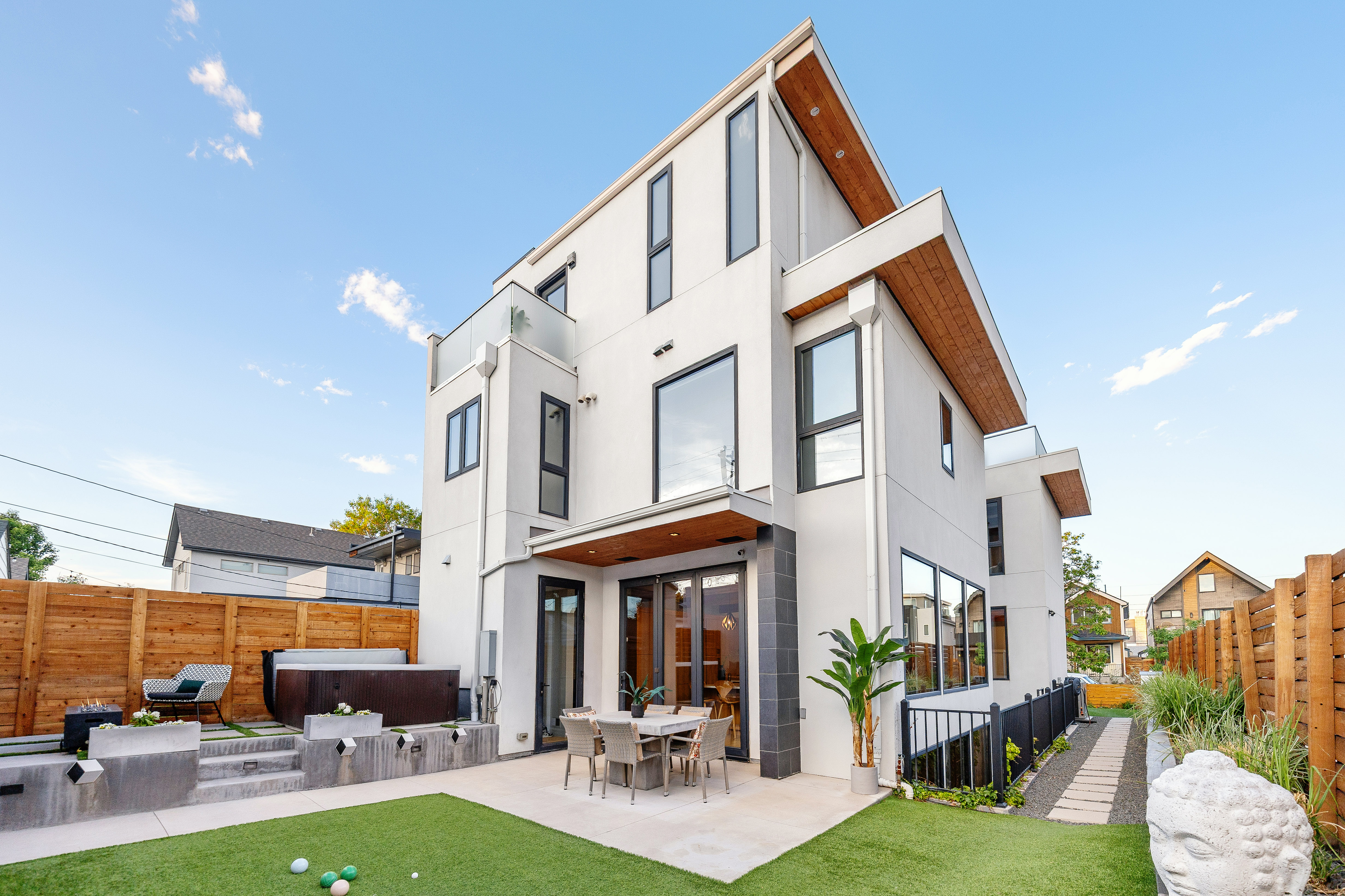 The homeâs backyard features an elevated hot tub terrace, a...