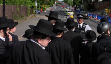 Members of the community watch as forensic officers search the area after two people were stabbed in the Golders Green neighborhood, which has a large Jewish community, in London, April 29, 2026. (AP Photo/Kin Cheung, File)