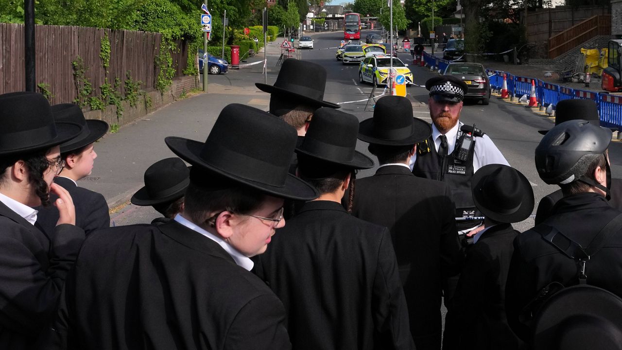 Members of the community watch as forensic officers search the area after two people were stabbed in the Golders Green neighborhood, which has a large Jewish community, in London, April 29, 2026. (AP Photo/Kin Cheung, File)