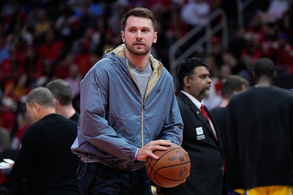 Luka Doncic holds a basketball during a timeout.
