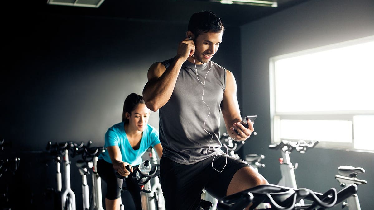 Man listening to music while working out on an exercise bicycle