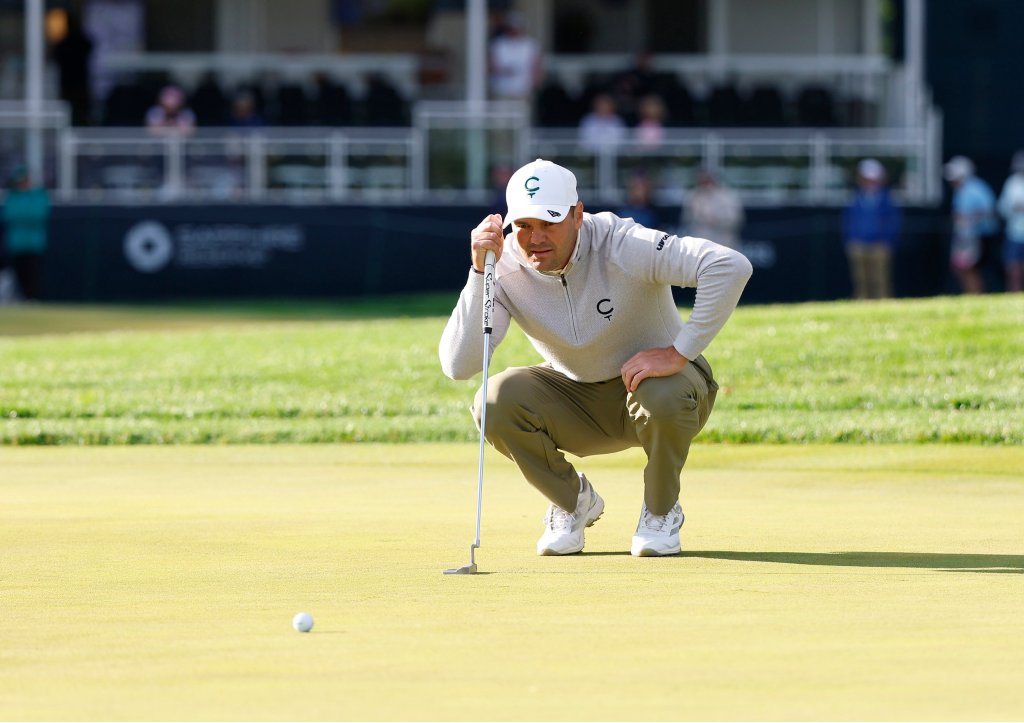 Golfer Martin Kaymer crouching to line up a putt during the 2026 PGA Championship.