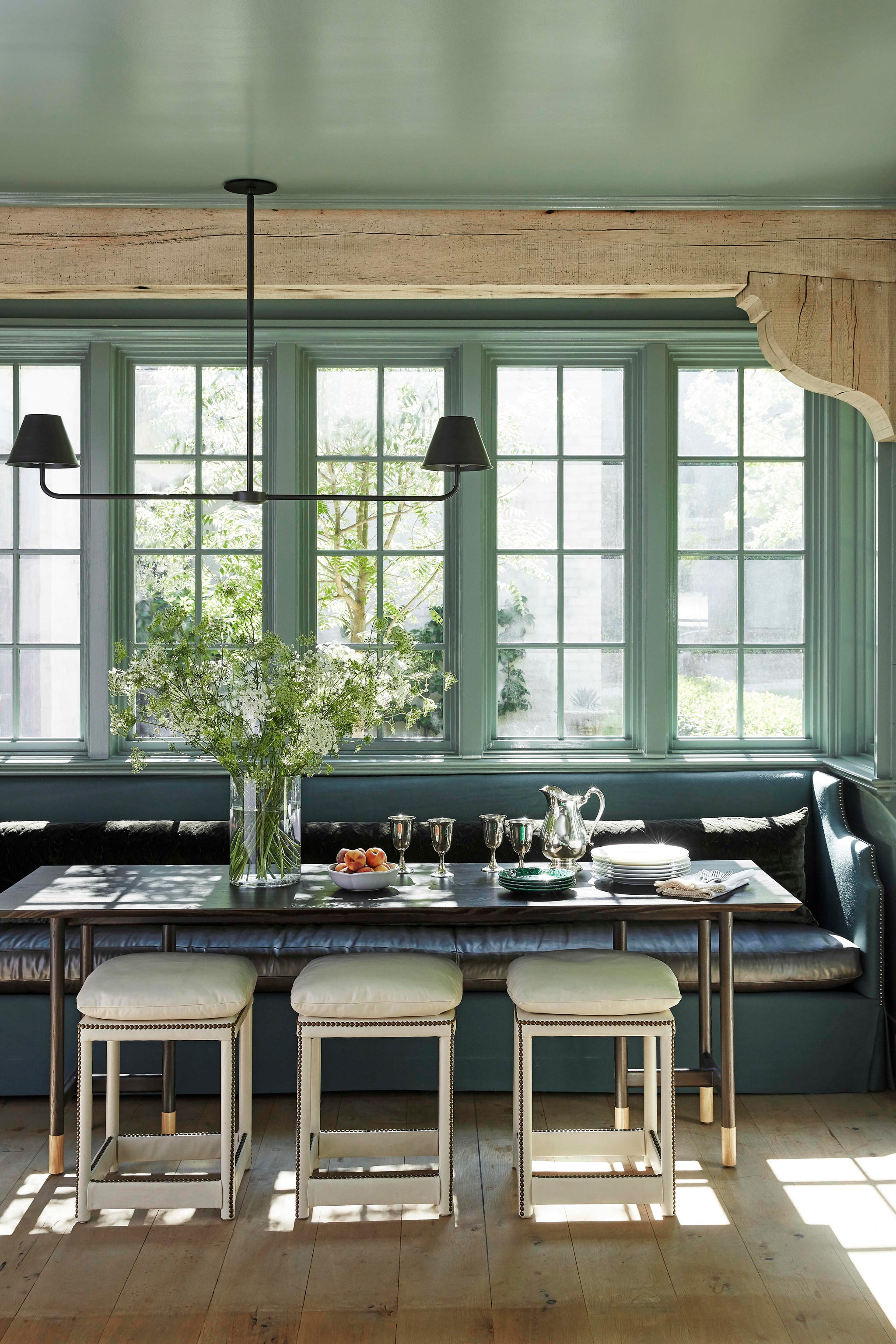 melanie pounds mountain brook house tour breakfast room the breakfast room is painted high gloss castle gray by farrow and ball and the ivory leather stools are custom theres a built in leather banquette