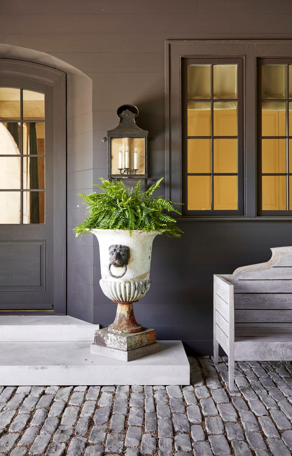 melanie pounds mountain brook house tour entrance an antique urn and paul ferrante lantern at the porte cochere entrance