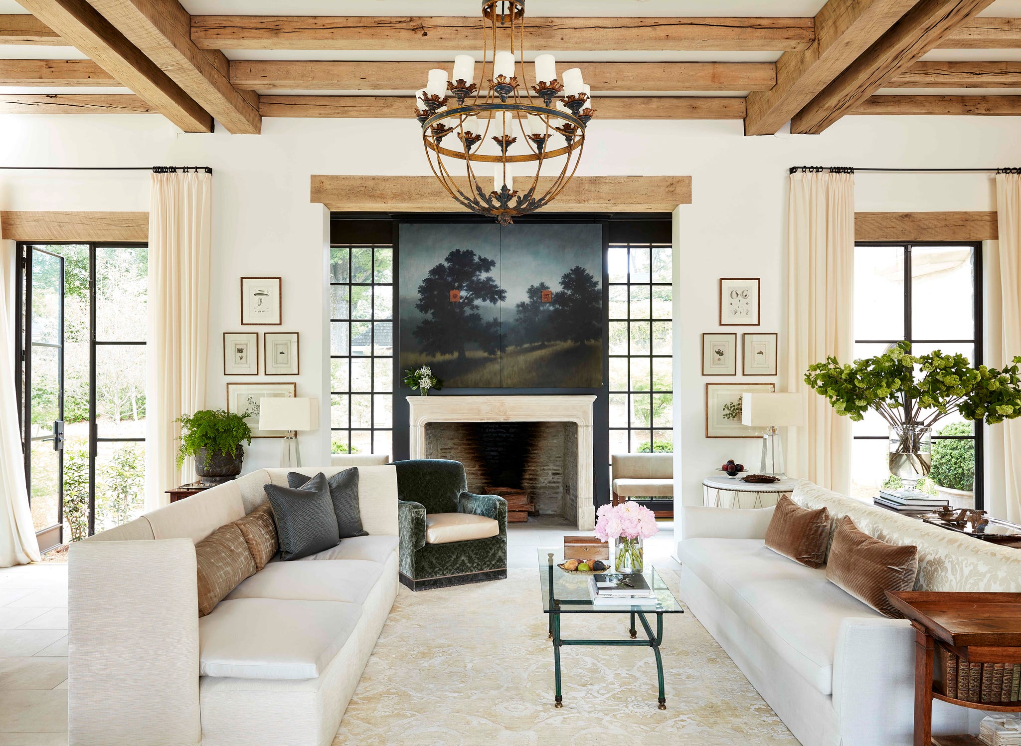 melanie pounds mountain brook house tour living room fireplace two sofas face each other in a large living space with a landscape painting hanging above the fireplace