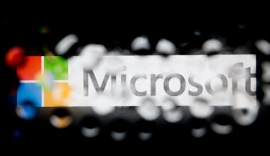 The Microsoft Corp. logo is seen through water droplets.