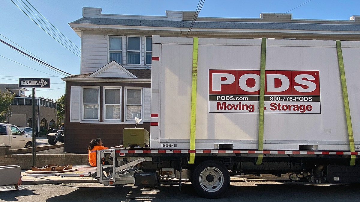 A moving truck in front of a house