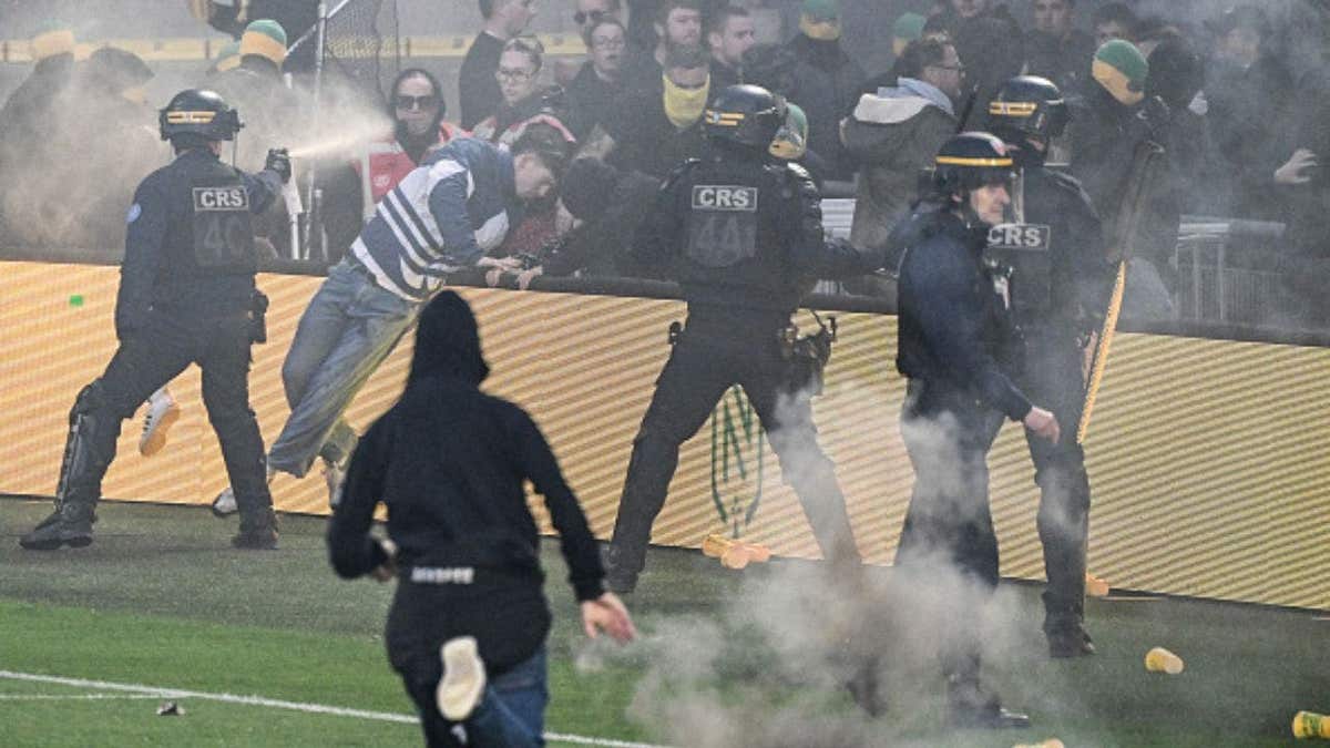 Anti-riot police officers spray tear gas at Nantes' supporters attempting to invade the pitch during the French L1 football match between FC Nantes and Toulouse FC at the Stade de la BeaujoireLouis Fonteneau in Nantes, western France, on May 17, 2026. (Photo by Sebastien Salom-Gomis / AFP via Getty Images)