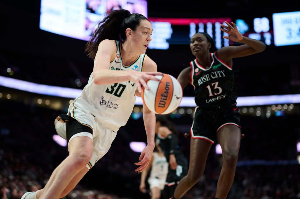 New York Liberty forward Breanna Stewart (30) drives to the basket while being defended by Portland Fire forward Nyadiew Puoch (13).