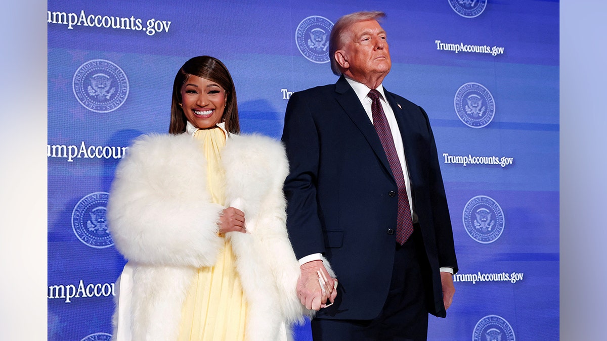 U.S. President Donald Trump and musician Nicki Minaj holding hands onstage