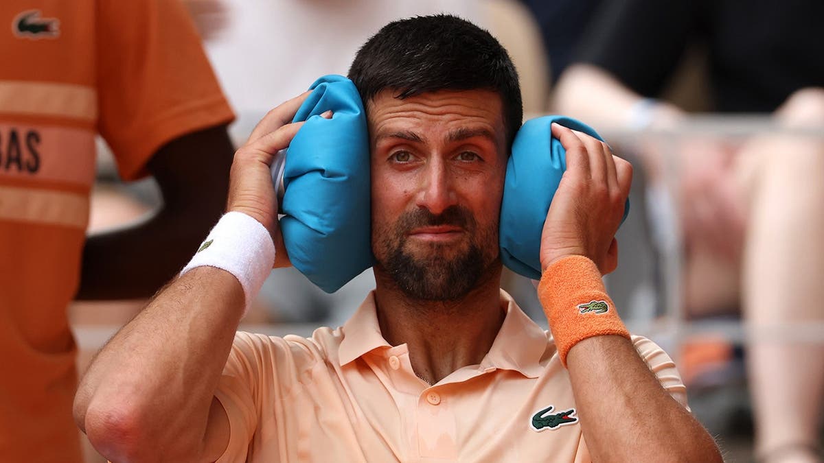 Novak Djokovic cooling down with two ice bags during tennis match at French Open
