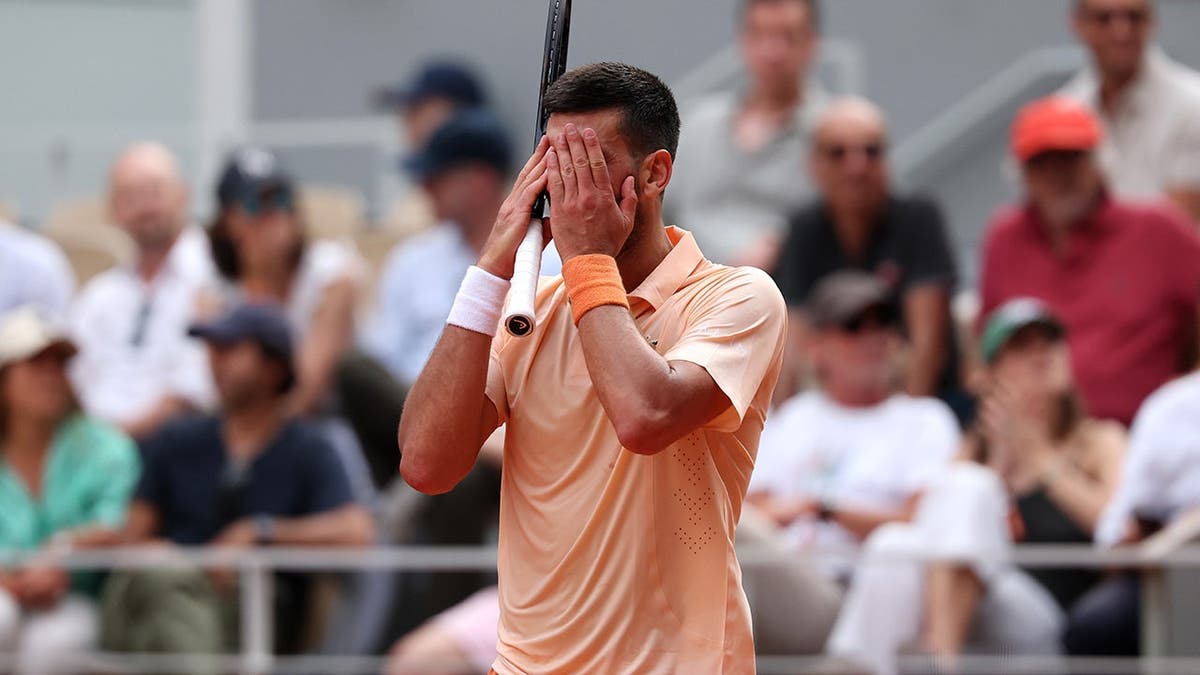 Novak Djokovic reacting during a tennis match against Joao Fonseca at the French Open in Paris