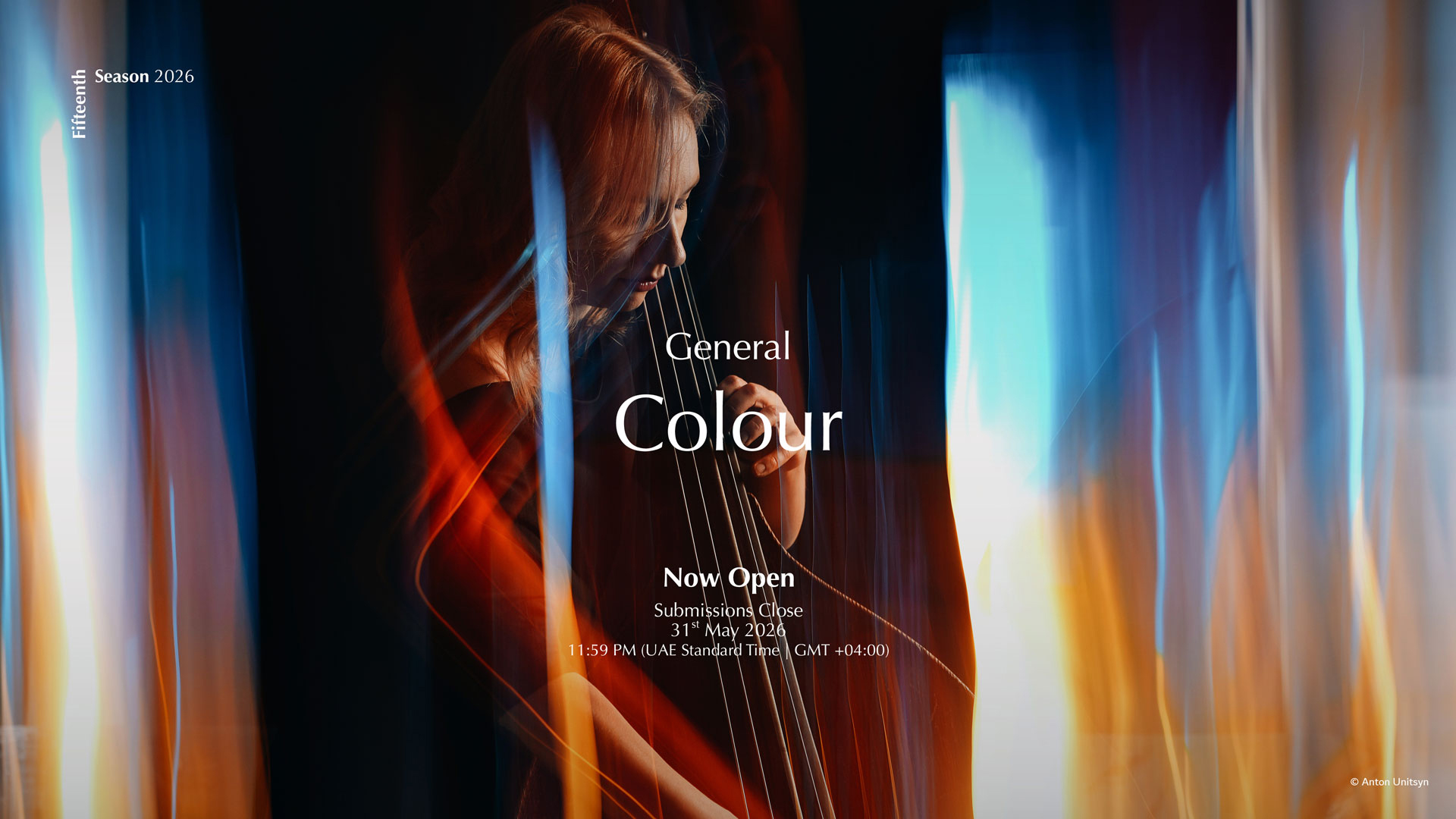 A woman playing a cello against a backdrop of vibrant, blurred lights in blue, orange, and red hues. Text overlay: "General Colour, Now Open, Submissions Close 31st May 2024 at 11:59 PM"