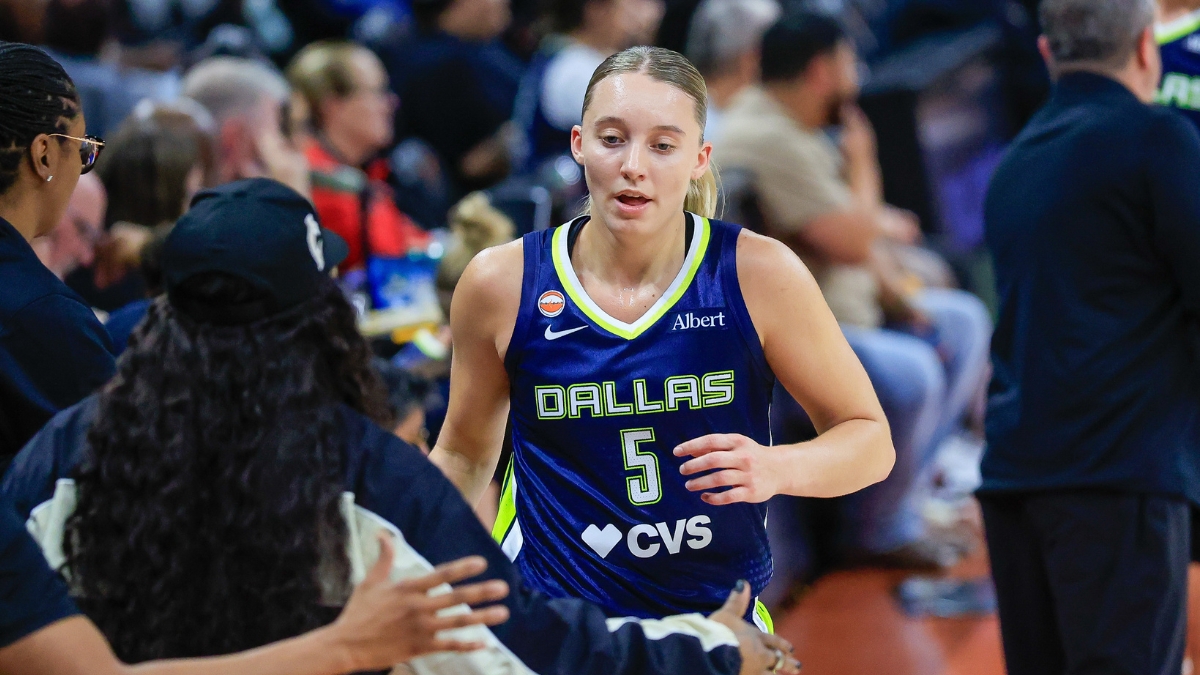 Paige Bueckers (5) and Arike Ogunbowale (24) of the Dallas Wings exchange a high five.