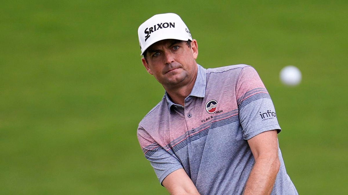 Keegan Bradley chipping golf ball toward 18th green at Tour Championship in Atlanta
