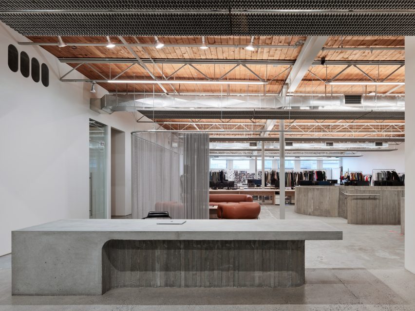 A concrete reception counter and a chainmail curtain behind