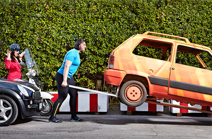 woman carrying car