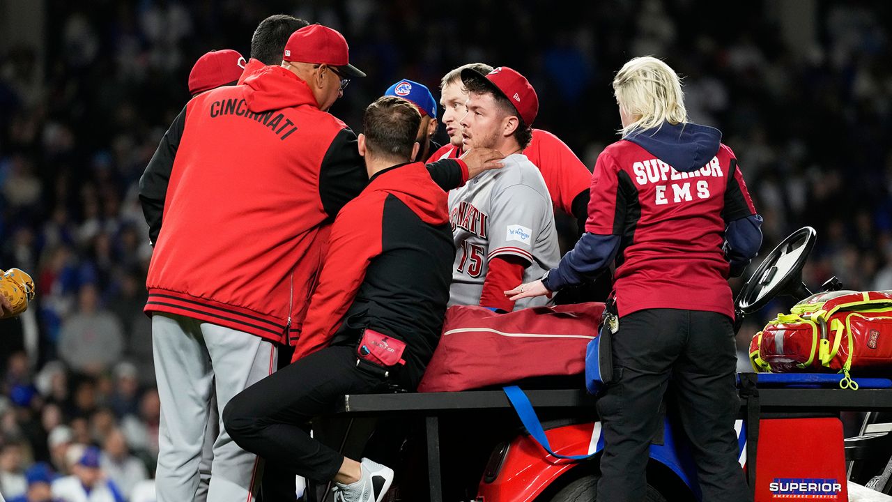 Cincinnati Reds manager Terry Francona, left, talks to relief pitcher Emilio Pagán, as he leaves the field after an injury during the ninth inning of a baseball game against the Chicago Cubs in Chicago, Tuesday, May 5, 2026. (AP Photo/Nam Y. Huh)