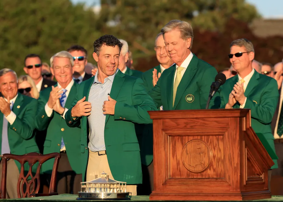 Rory McIlroy of Northern Ireland is presented with his Green Jacket