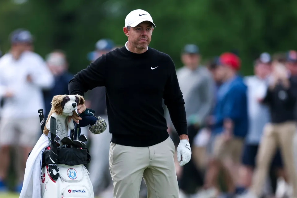 Rory McIlroy of Northern Ireland selects a club from his bag on the 13th hole during the first round of the PGA Championship