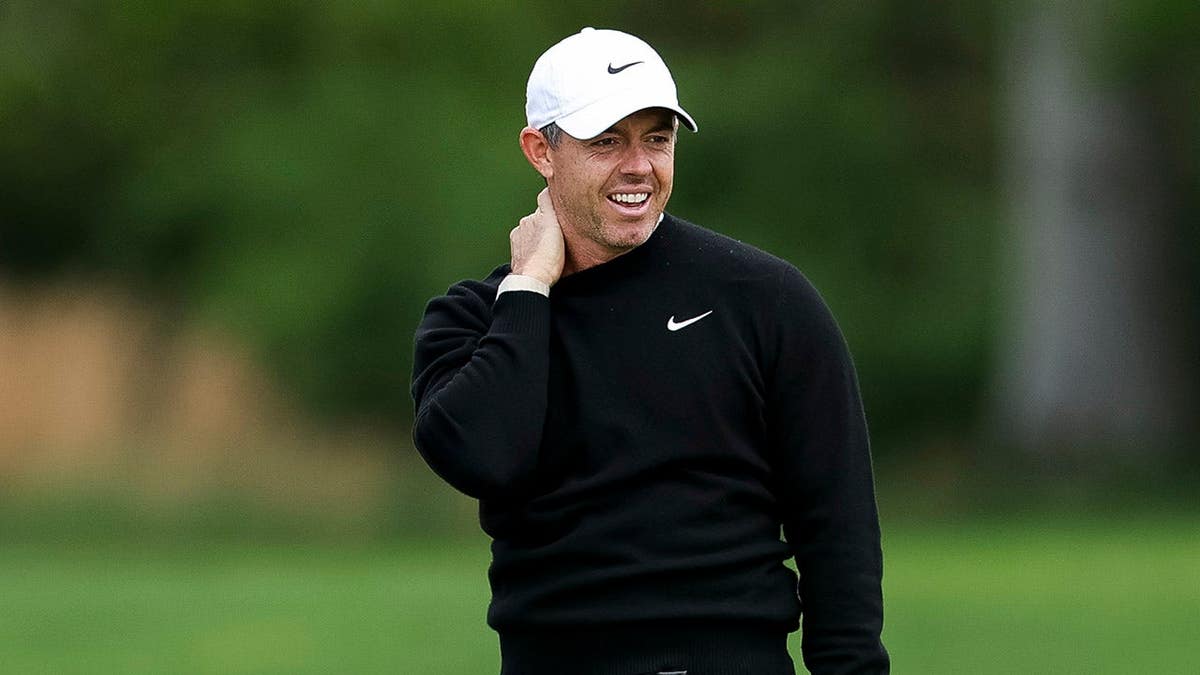 Rory McIlroy reacting after playing a shot on the first hole at Aronimink Golf Club