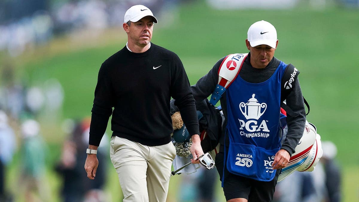 Rory McIlroy walking the 12th hole with caddie Harry Diamond at Aronimink Golf Club