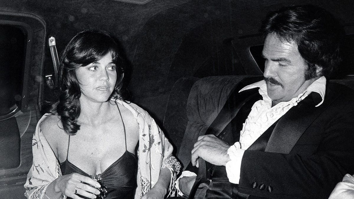 Sally Field and Burt Reynolds standing together at an awards event