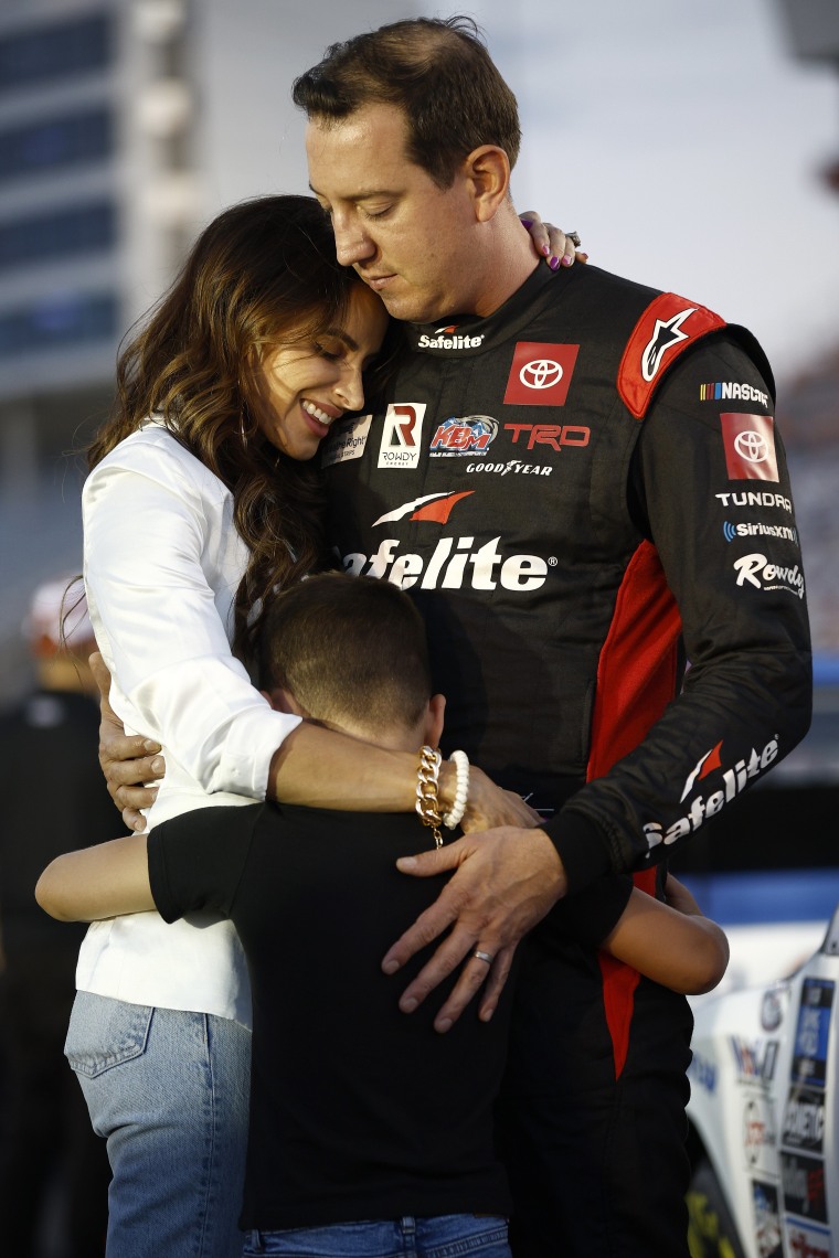 Kyle Busch embraces his wife, Samantha, and son, Brexton, prior to a race in 2022.