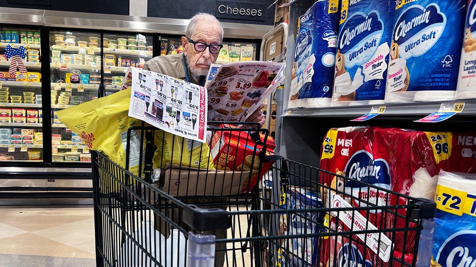 A shopper looks at coupons