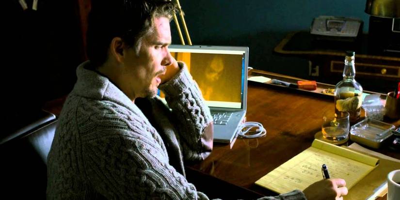 Ellison on the phone while the demon Bhagul appears on his laptop screen in 'Sinister' (2012)