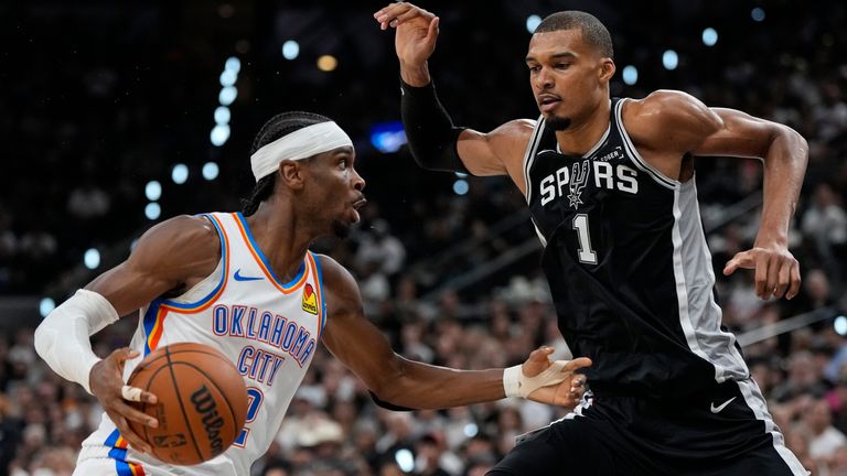 Oklahoma City Thunder guard Shai Gilgeous-Alexander drives against San Antonio Spurs forward Victor Wembanyama (AP Photo/David J. Phillip)