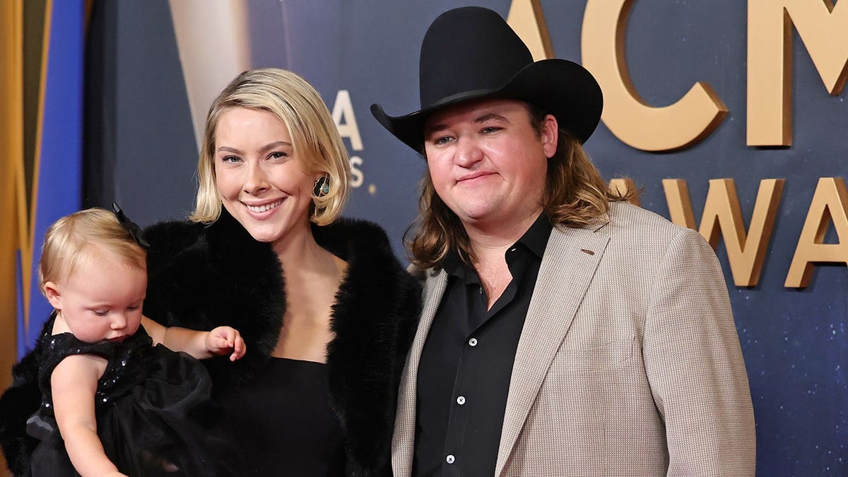 Sophie Worthington and Jake Worthington standing at the 59th Annual CMA Awards in Nashville, Tennessee