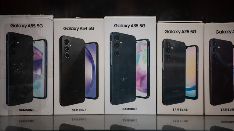 A series of Samsung Galaxy phone boxes on display in a store.