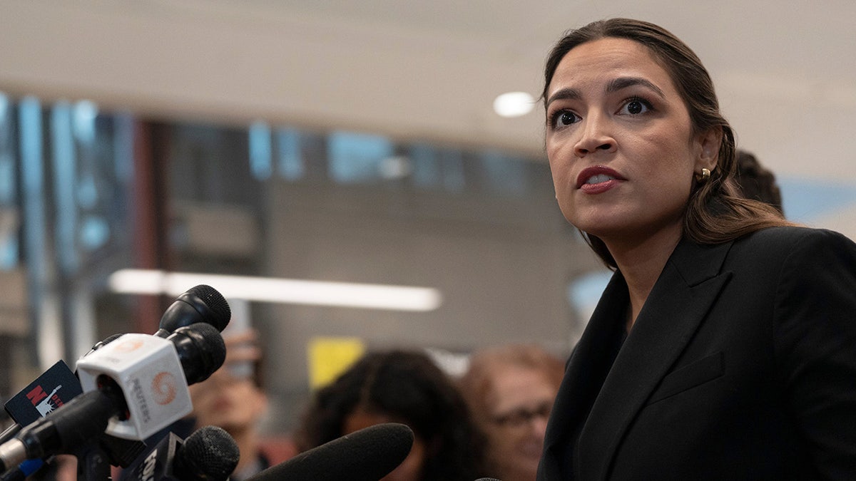Rep. Alexandria Ocasio-Cortez speaking to reporters at Newark Liberty International Airport