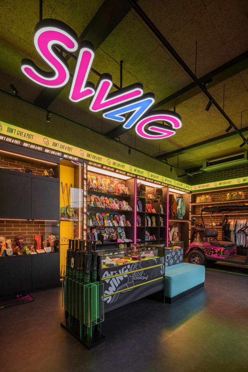 monochrome surfaces and neon accents outline swag golf bangkok flagship - 7