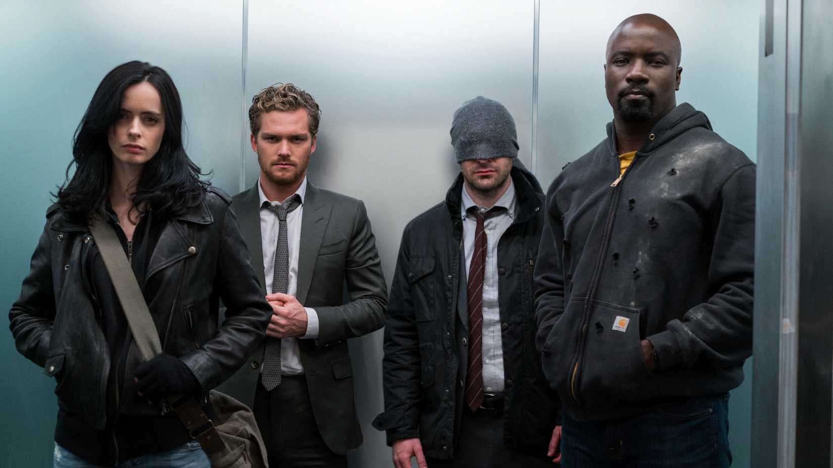 The titular team from The Defenders standing in an elevator