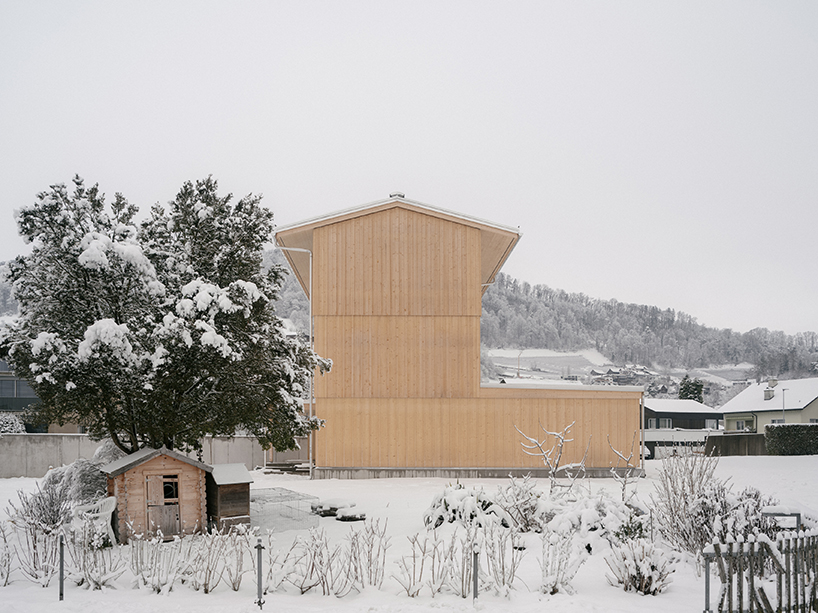 the tower house explores vertical living through prefabricated timber design 1